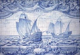 Traditional Portuguese azulejo tiles depicting a historic kitchen scene with ceramic cookware, fresh ingredients, and figures preparing food in blue and white ceramic artistry