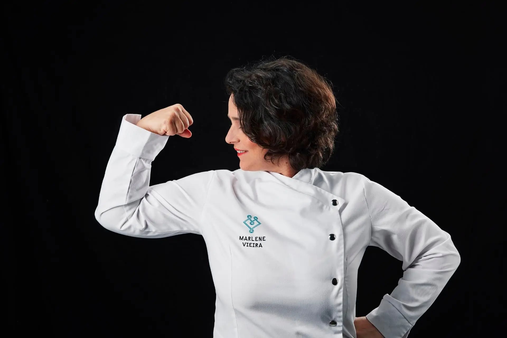 A female chef in a modern Portuguese kitchen, working with traditional ingredients while incorporating contemporary techniques, representing the evolution of Portuguese gastronomy through women's influence